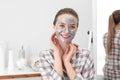 Young woman with cleansing mask on her face. Skin care Royalty Free Stock Photo