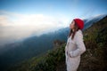 Young woman on a cliff overlooking the mountains Royalty Free Stock Photo