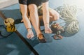 Young woman climber prepare before to climbing on the boulder wall indoor with equipment, shoe, rope, carabiner, concept Royalty Free Stock Photo