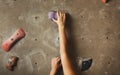 Young woman climbing artificial rock wall at gym Royalty Free Stock Photo