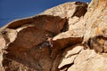 Young woman climbing at the high rock Royalty Free Stock Photo