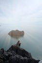 Young woman climbing sit on top of mountain front of her have sk