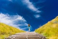 Young woman climbing stairs outdoors in an idyllic travel destin Royalty Free Stock Photo