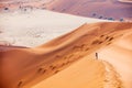 Young woman climbing up red sand dune Royalty Free Stock Photo