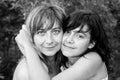 A young woman in close-up black-and-white portrait embraces her daughter. Love. Royalty Free Stock Photo