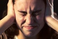 A young woman close-up with headache on black background. Mental illness concept Royalty Free Stock Photo