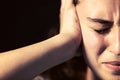 A young woman close-up with headache on black background. Mental illness concept Royalty Free Stock Photo