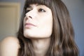 Young woman close-up portrait. Caucasian with brown long hair and bangs