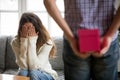 Young woman closing eyes with hands waiting for present surprise