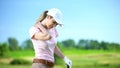 Young woman with club playing golf, suffering sharp shoulder pain, sports trauma Royalty Free Stock Photo