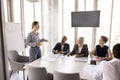 Young woman coach leads formal meeting in board room Royalty Free Stock Photo