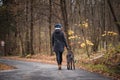 Girl In Coat And Cap On Her Head Walks With Her Dog On Damp Early Winter Morning. Authentic Women With Her Best Friend Bohemian