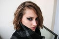 Young woman in coat with dark smoky eyes makeup Royalty Free Stock Photo