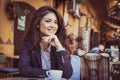 Young woman at coffee break. Looking at camera. Royalty Free Stock Photo