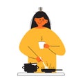 Young woman with coffee cup in hand cooking homemade meal frying in pan on stove