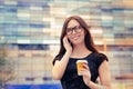 Young Woman with Coffee Cup on the Phone Out in the City Royalty Free Stock Photo