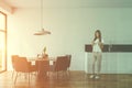 Woman in white dining room interior Royalty Free Stock Photo