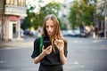 Young woman with coin bitcoin and smartphone in hand on the back Royalty Free Stock Photo