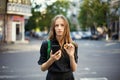 Young woman with coin bitcoin and smartphone in hand on the back Royalty Free Stock Photo