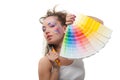 Young woman with a color guide and paintbrushes. Royalty Free Stock Photo