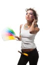 Young woman with a color guide and paintbrushes. Royalty Free Stock Photo