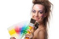 Young woman with a color guide and paintbrushes. Royalty Free Stock Photo