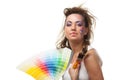 Young woman with a color guide and paintbrushes. Royalty Free Stock Photo