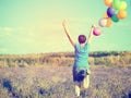 Young woman with colorful ballons