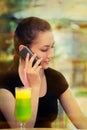 Young Woman with Colorful Cocktail Drink Talking on Her Phone Royalty Free Stock Photo