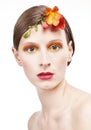 Young woman with colorful make-up and a flower