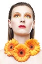 Young woman with colorful make-up and gerbera
