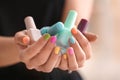 Young woman with colorful manicure holding bottles of nail polishes, closeup Royalty Free Stock Photo