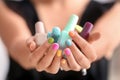 Young woman with colorful manicure holding bottles of nail polishes, closeup Royalty Free Stock Photo