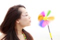 Young woman and colourful pinwheel Royalty Free Stock Photo