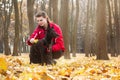 Young woman combing a dog in red collar