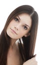 Young woman combing her hair