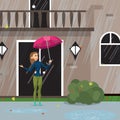 Young woman comes out of the house with an umbrella