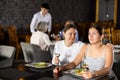 Young woman comforting upset female friend in restaurant Royalty Free Stock Photo