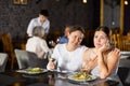 Young woman comforting upset female friend in restaurant Royalty Free Stock Photo