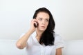 Young woman communicates via her cell phone with upset expression Royalty Free Stock Photo