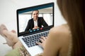 Young woman communicating with man via video call application.