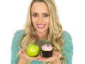 Young Woman Comparing Good and Bad Food Royalty Free Stock Photo