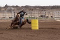 Young woman competing in a barrel race in small town in West Texas