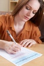 Young Woman Completing Employment Application Form