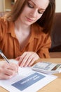 Young Woman Completing Loan Application Form