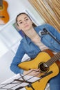 young woman compose song and play guitar