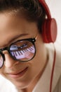 Young woman composer with a reflection of piano keys in a eyeglasses