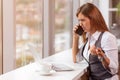 A young woman with computer and smartphone indoors, working in office. Royalty Free Stock Photo