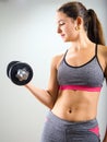 Young woman concentrating on dumbbell curl Royalty Free Stock Photo