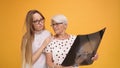 Young woman confronting worried senior lady holding a x-ray o MRI head scan